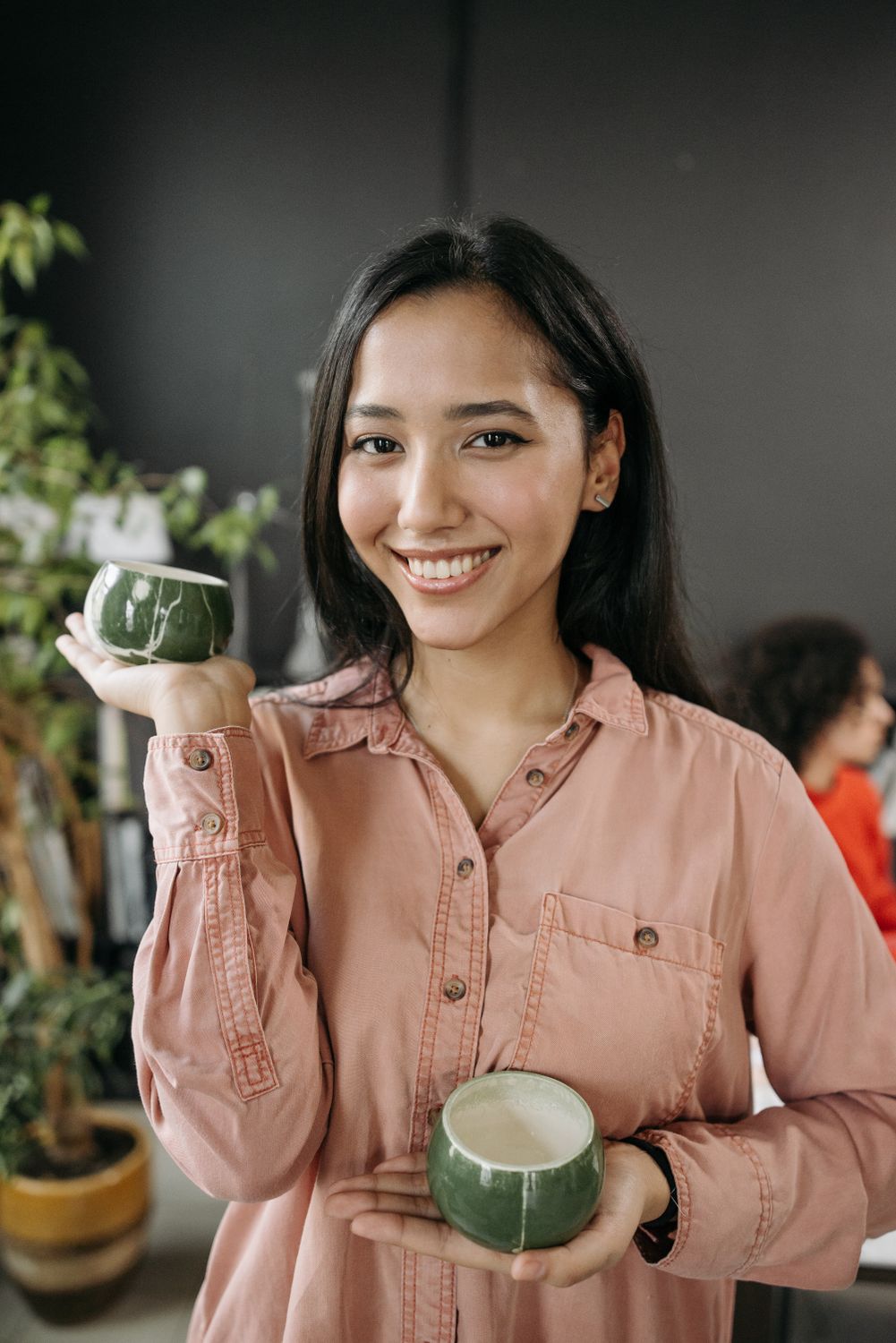 A Woman Holding a Ceramic Cups · Free Stock Photo
