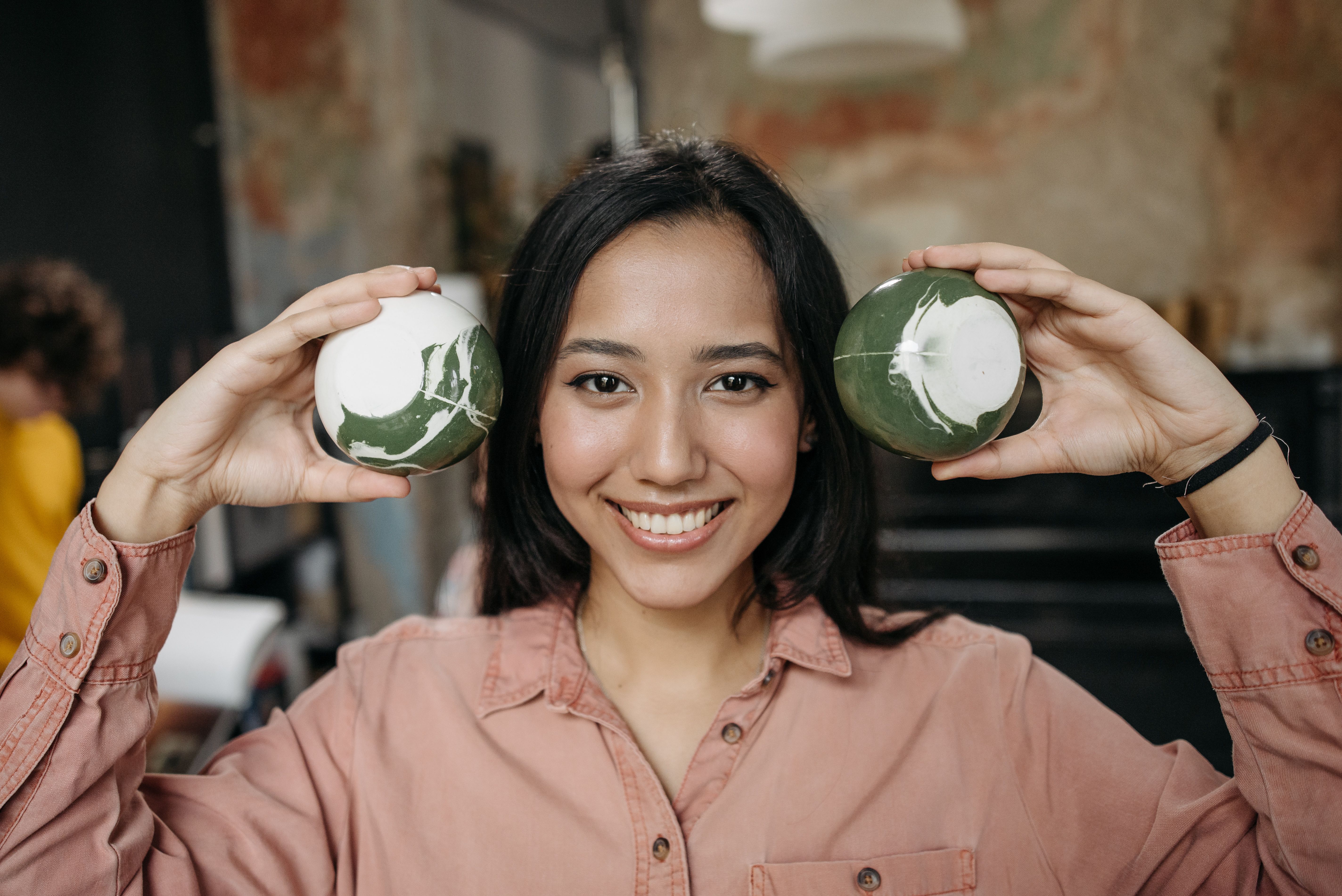 A Woman Holding Ceramic Cups · Free Stock Photo