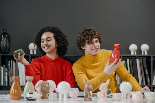 Free Two young adults displaying modern ceramics in a creative workspace. Stock Photo