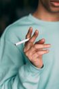 Unrecognizable man with cigarette in hand