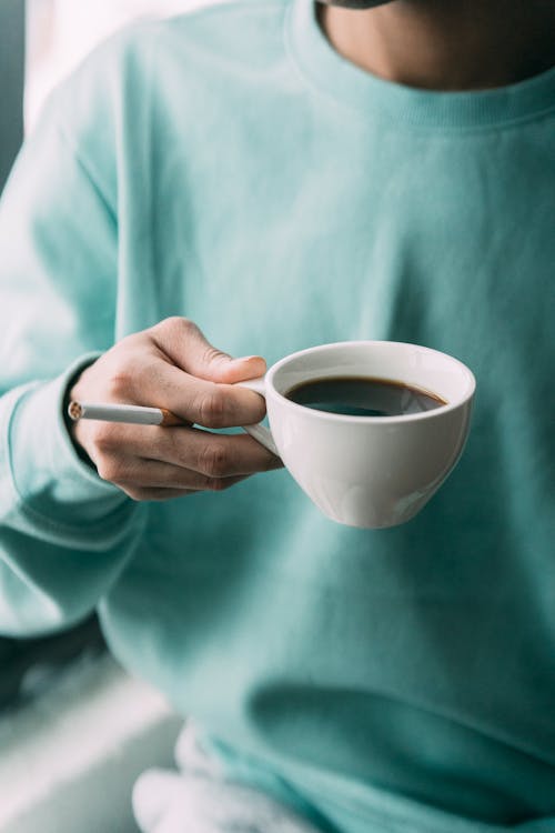 Free Faceless smoker with hot coffee Stock Photo