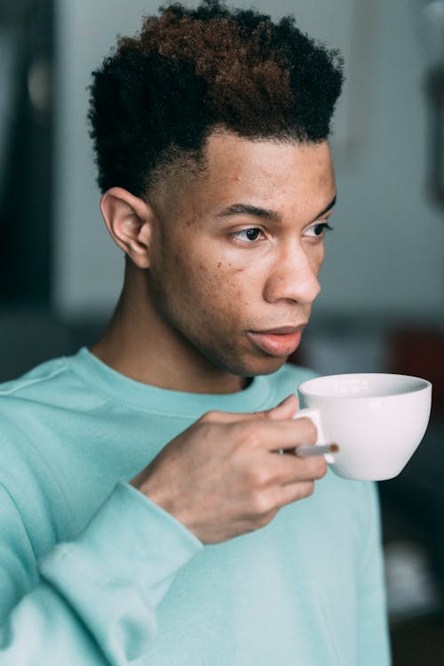 Free Pensive black man with cup of coffee Stock Photo