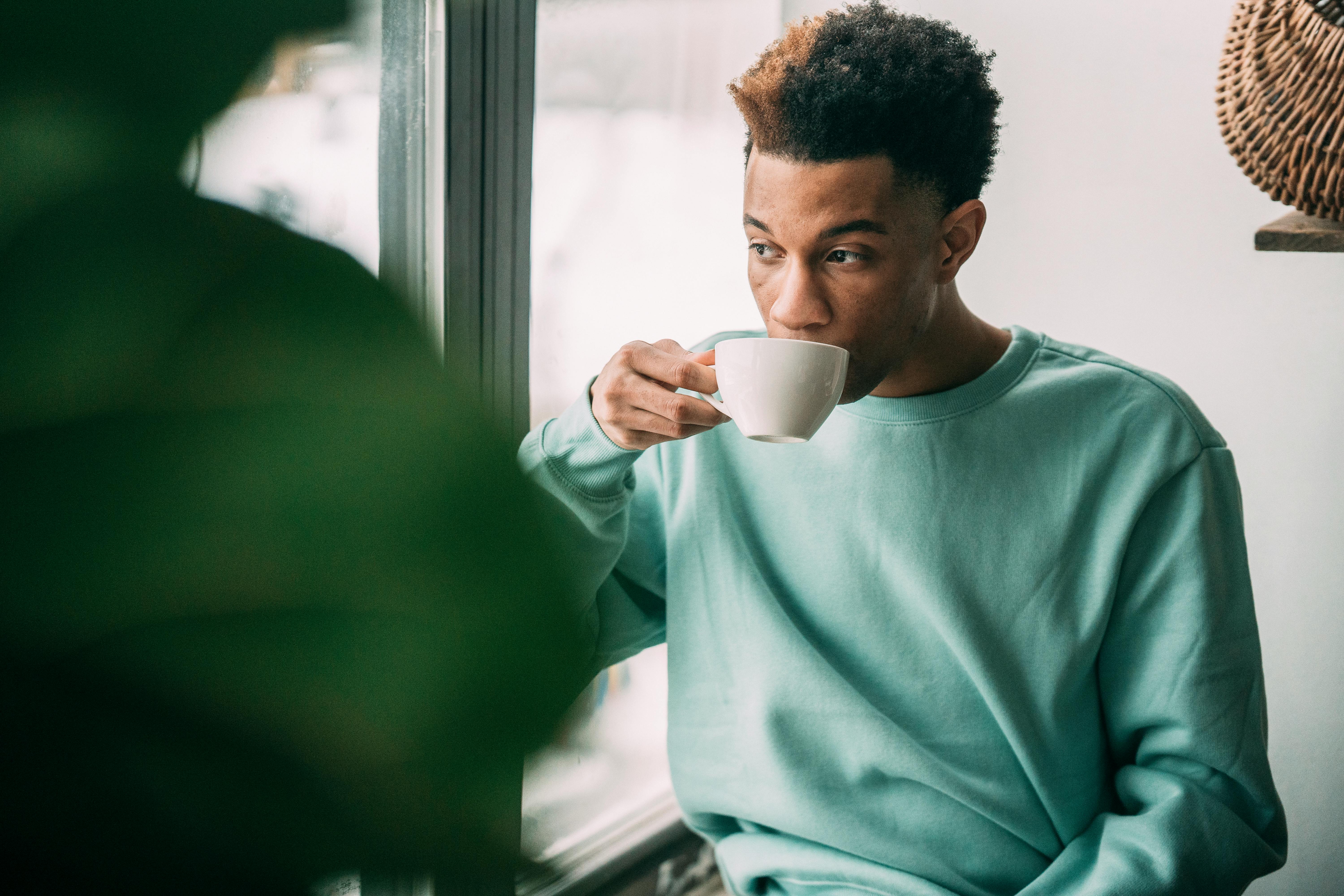 Focused Man Drinking From Cup Stock Photo - Download Image Now - Men,  Coffee - Drink, Window - iStock