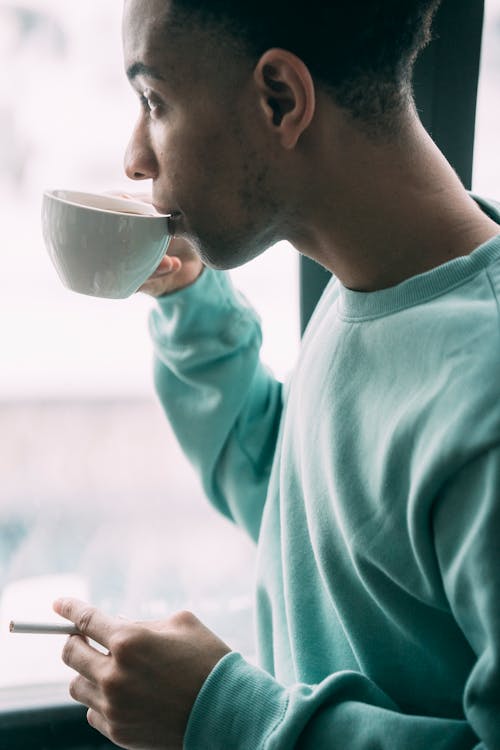 Free Black man with cigarette drinking coffee Stock Photo
