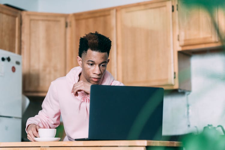 Serious Black Man Working On Laptop