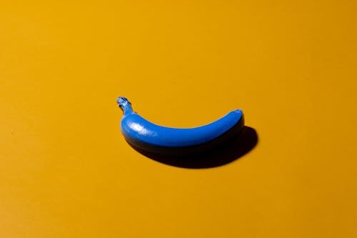Blue Banana on Yellow Surface