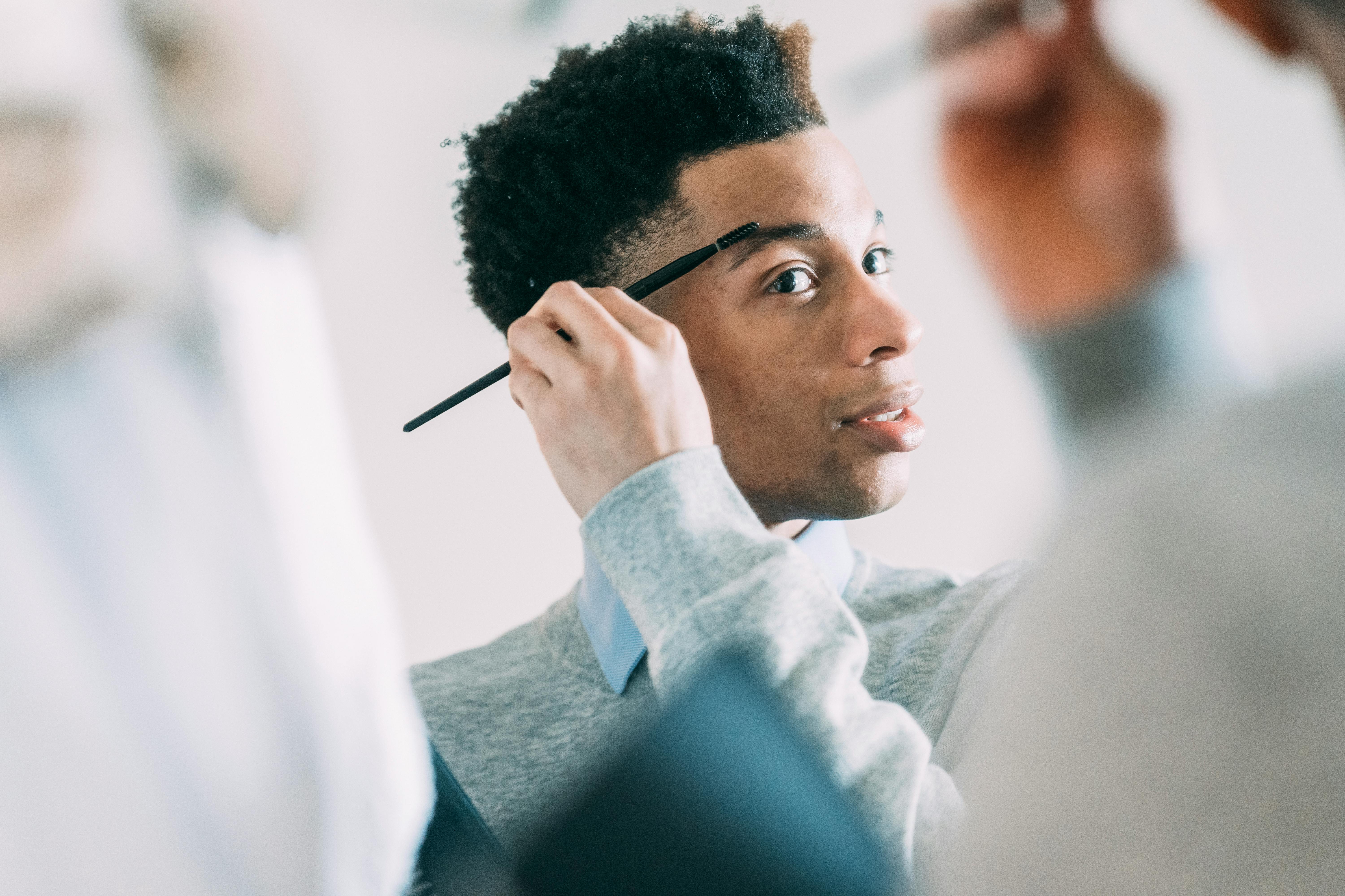 Black man with laptop looking at mirror · Free Stock Photo