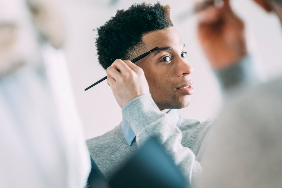 Black man using eyebrow brush