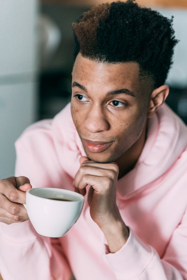 Pensive Black Man With Cup Of Coffee