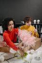 Woman in Red Long Sleeve Shirt Holding Pink Box Filler