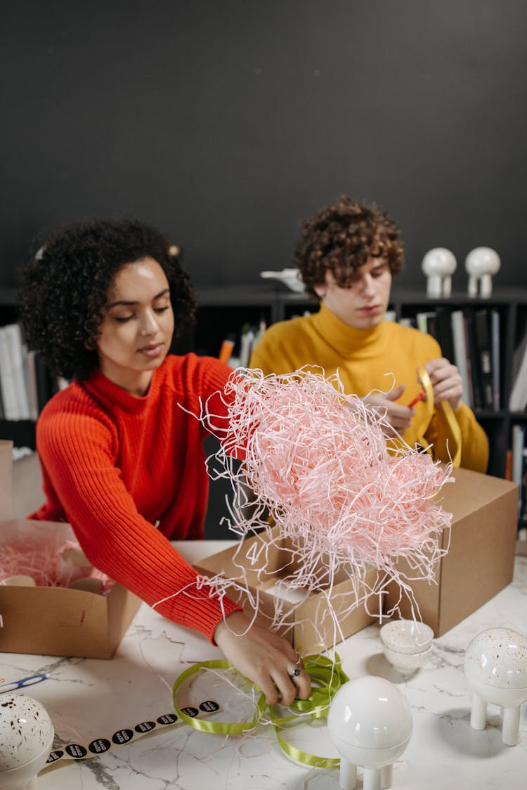 Woman In Red Long Sleeve Shirt Holding Pink Box Filler