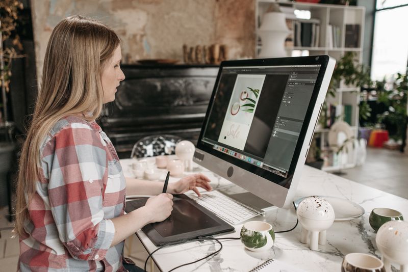 Graphic designer working on a tablet and laptop