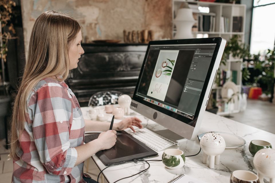 Designer drawing on a graphics tablet at her desk