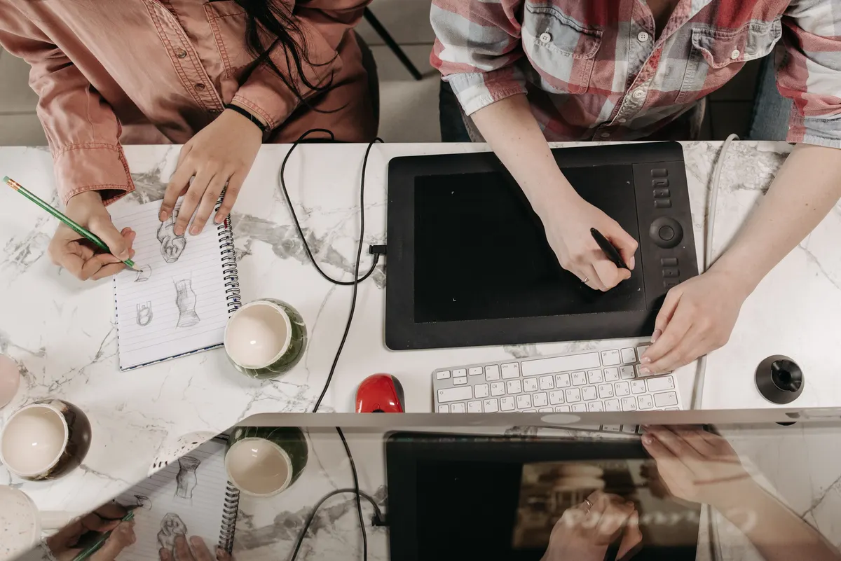 Designers collaborating on a project, highlighting the human editor vs AI workflow in content teams.
