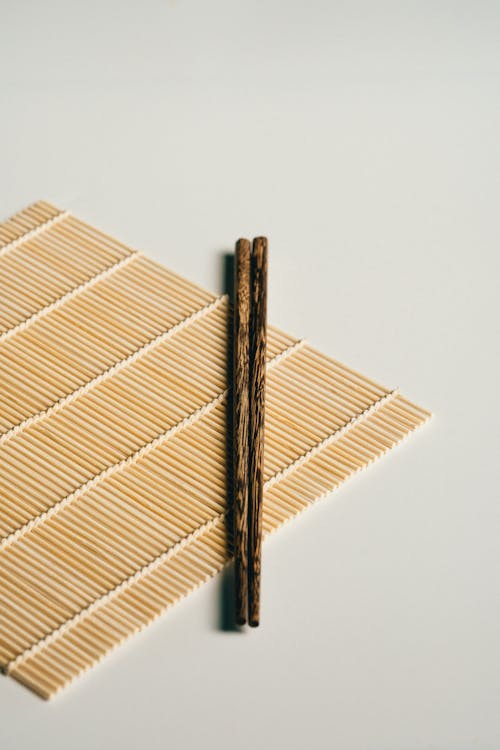 Free Wooden Chopsticks on Bamboo Mat Stock Photo