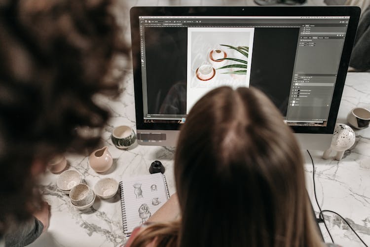 A Person Editing A Photo Using A Computer