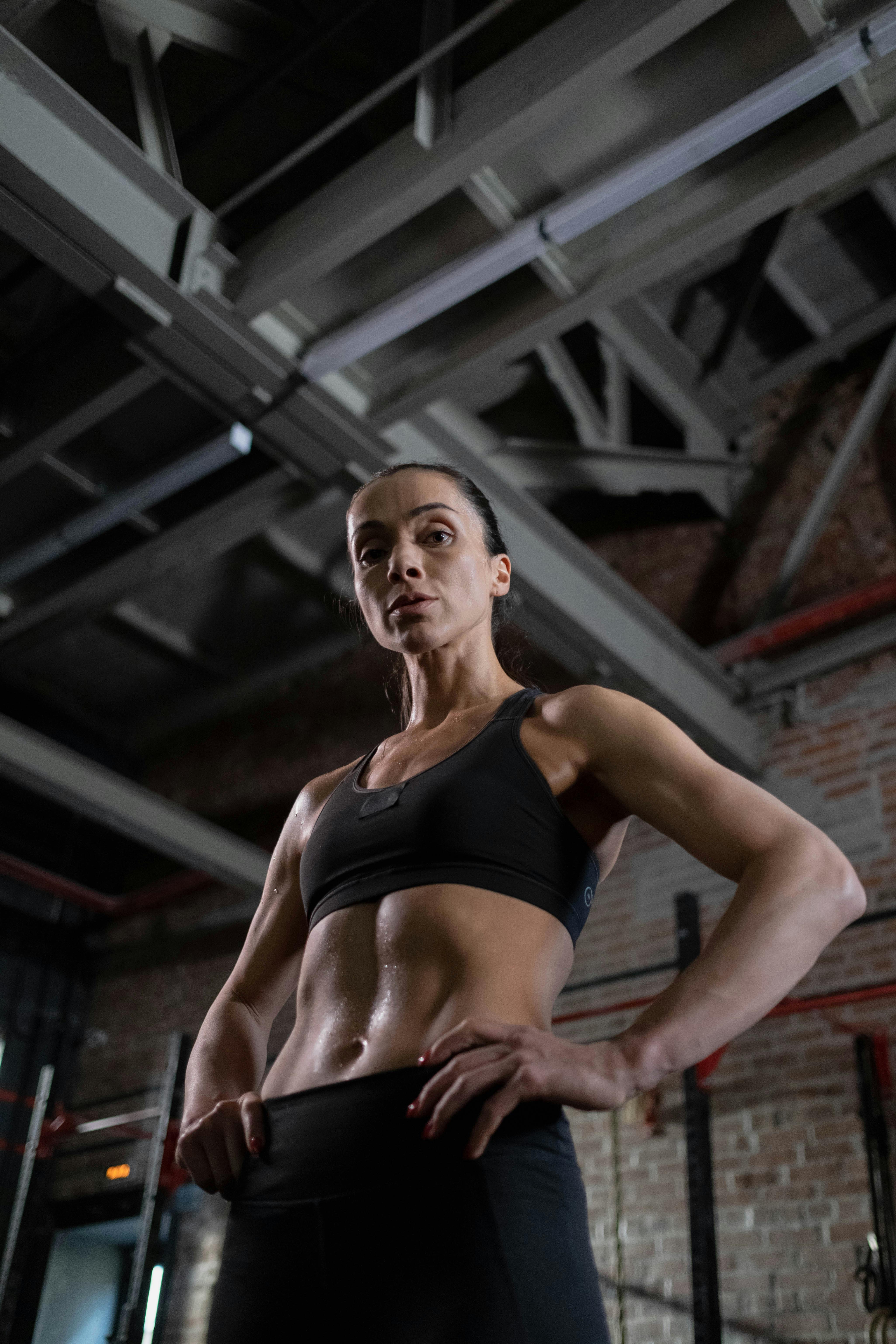 low angle shot of a woman in black sports bra