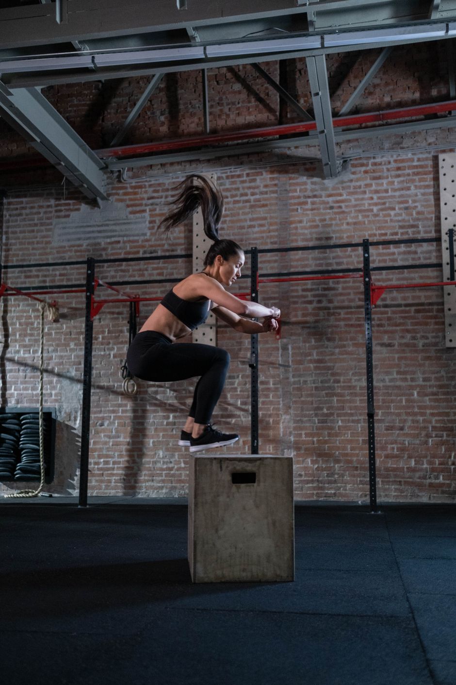 Athlete performing a box jump during a strength session