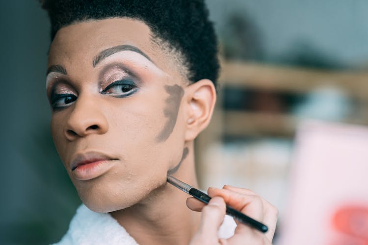 Black Man With Makeup Applying Contouring