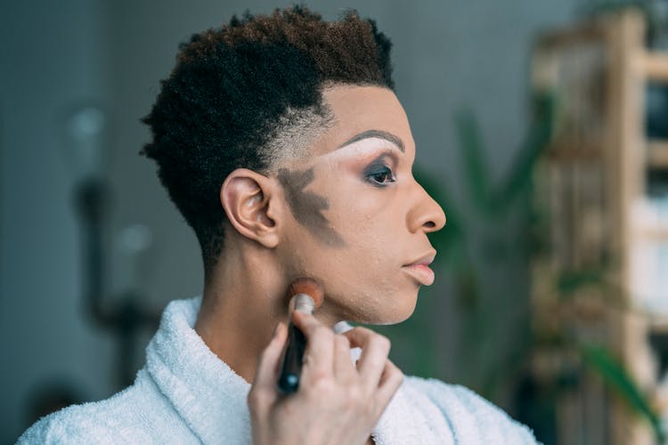 Black Man Blending Contour In Room