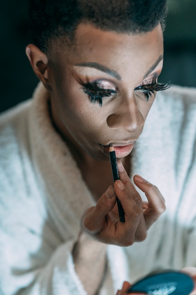 Queer Black Man Applying Lip Pencil