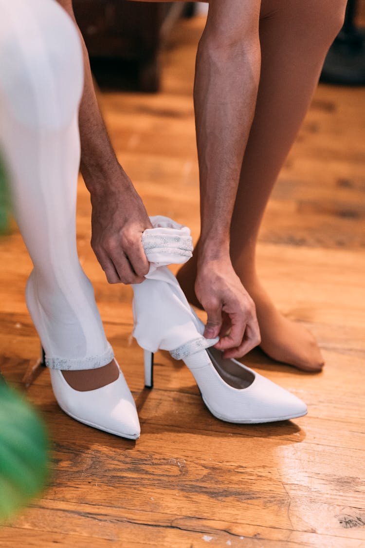 Crop Woman Putting On Shoes