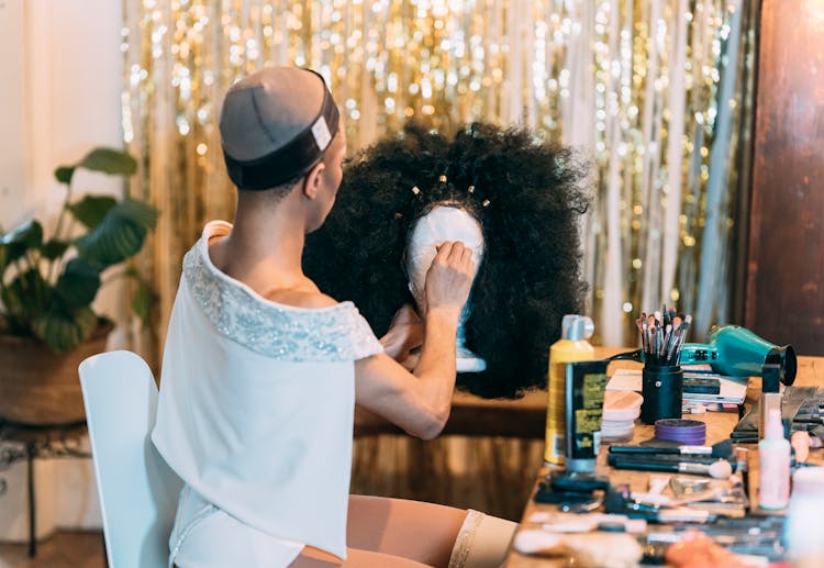 Woman In Hairnet With Wig Stand