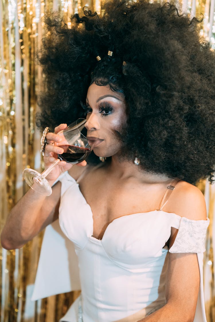 Drag Queen In Wig Drinking Wine