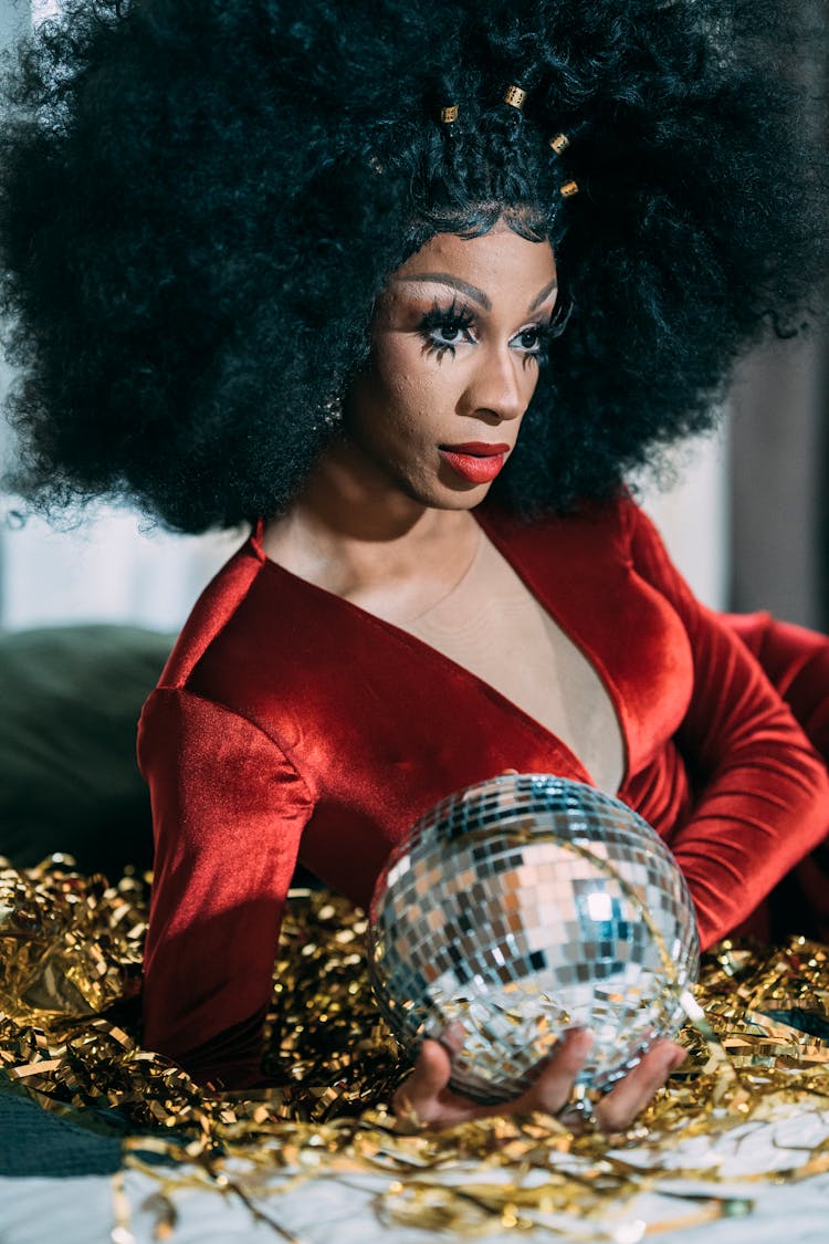 Drag Queen With Disco Ball On Bed