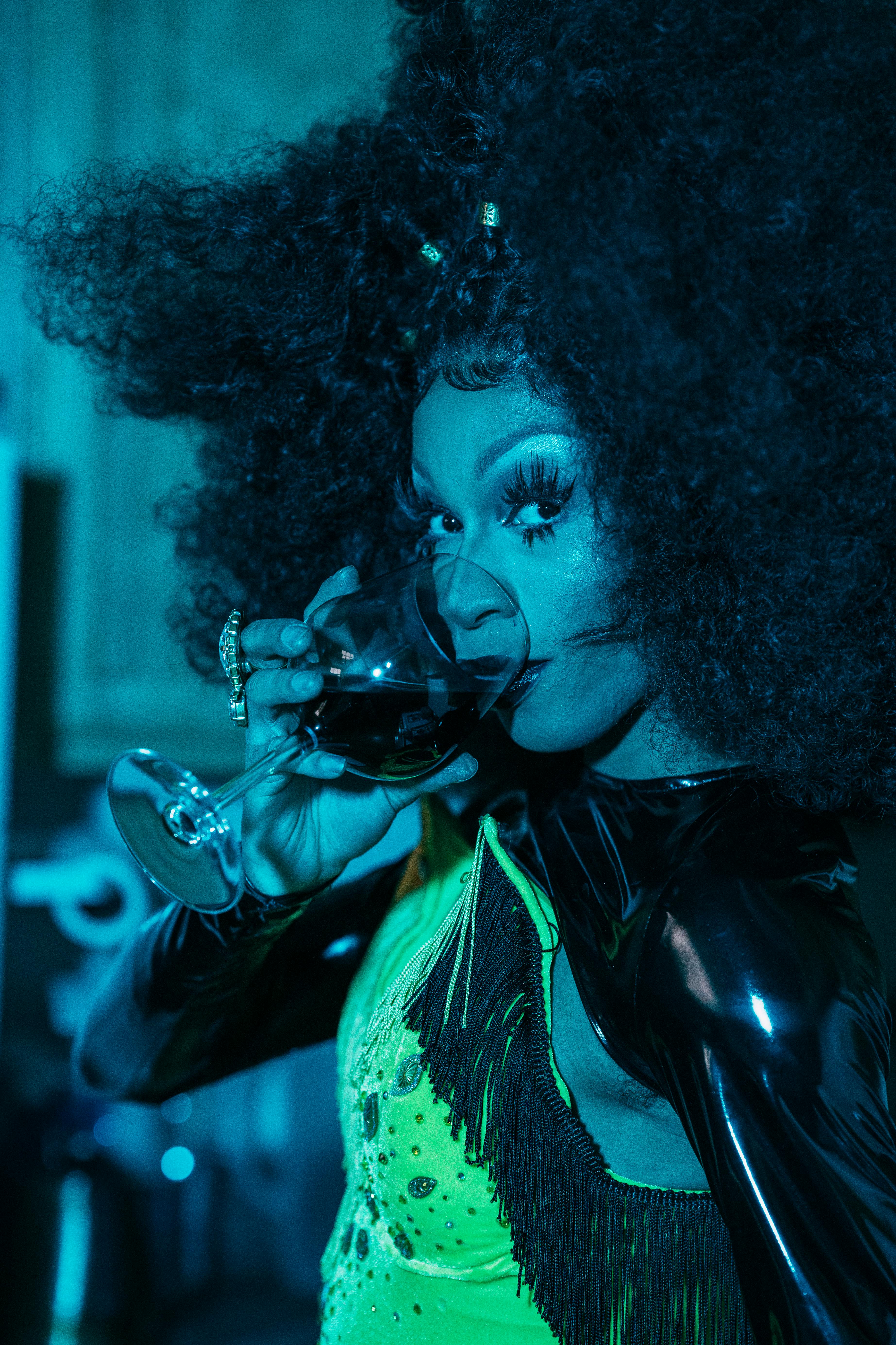 drag queen with glass of wine