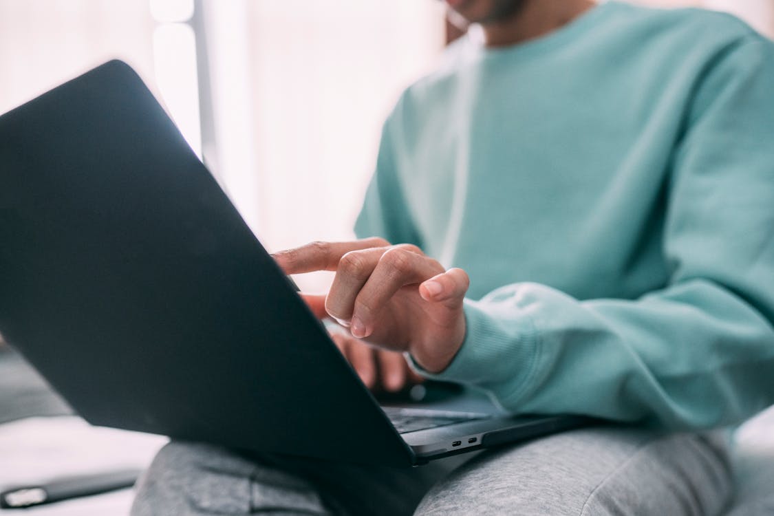 Free Crop man working on laptop Stock Photo