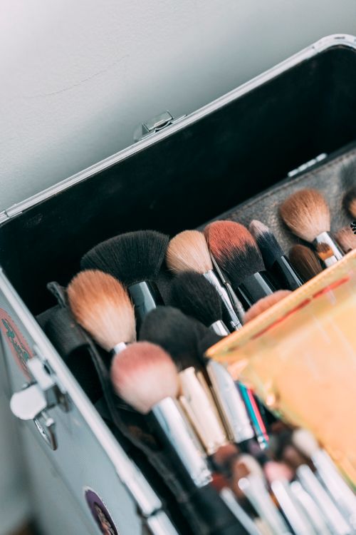 Free From above kit of various makeup brushes arranged together in professional case standing on floor near white wall in daylight Stock Photo