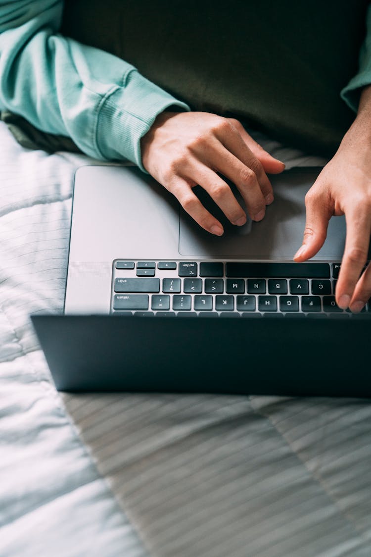 Person Typing On Laptop At Home