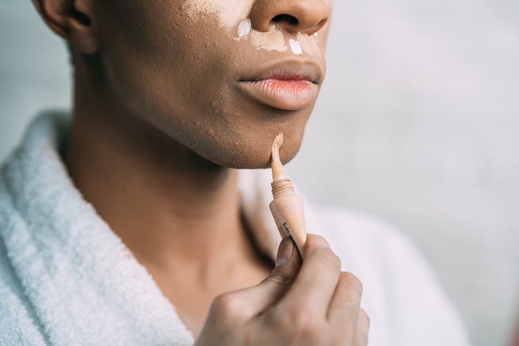Crop Black Man Doing Makeup With Foundation Cream