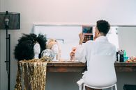 Unrecognizable man doing makeup in dressing room