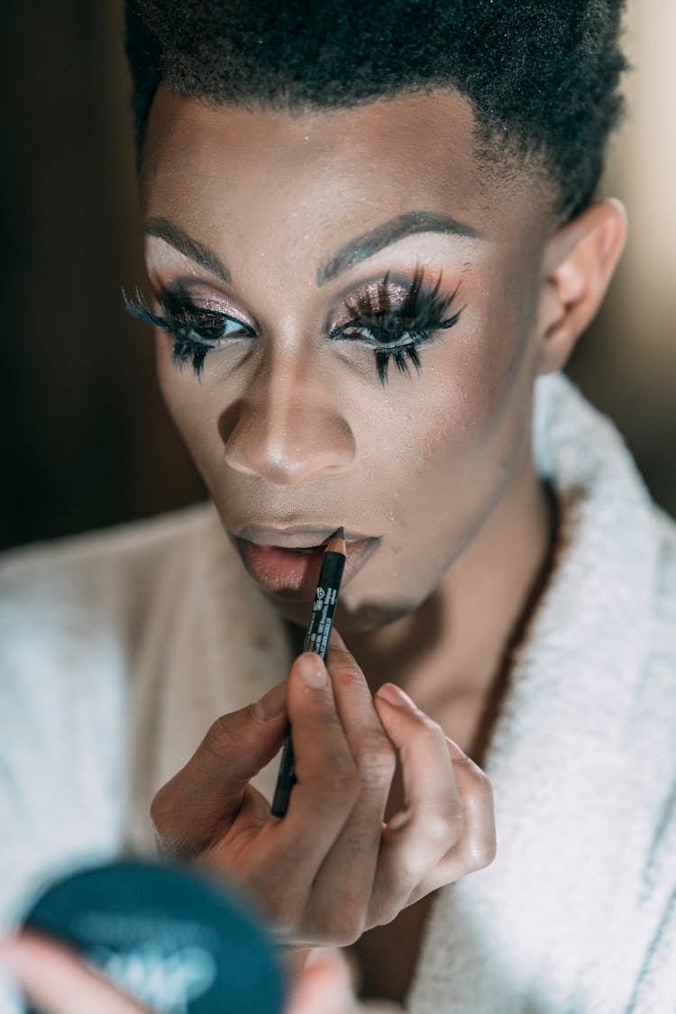 Transgender Man Applying Lip Liner