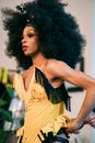 Stylish black drag queen in wig and stage costume