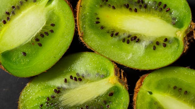 Vibrant kiwi slices showcasing texture and seeds, ideal for healthy food themes.