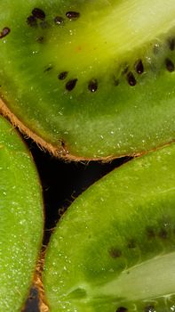 A detailed close-up of fresh kiwi fruit slices showing vibrant green texture and seeds.