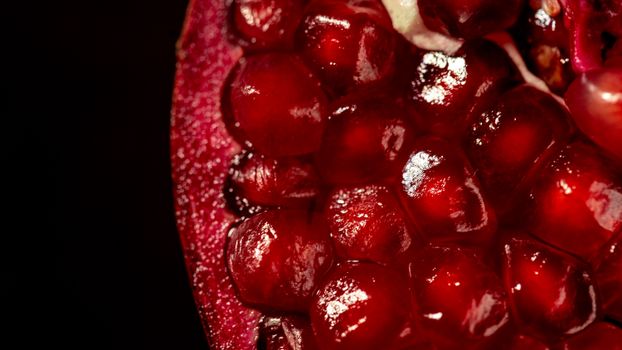 Close-up of vibrant red pomegranate seeds highlighting natural texture.