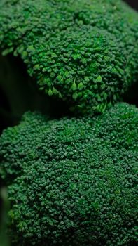 Detailed close-up of fresh green broccoli florets with visible texture, ideal for healthy food concepts.