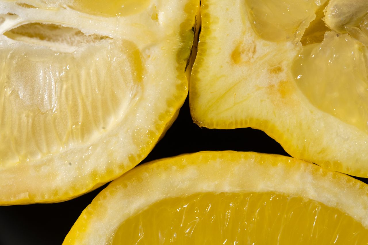 close up view of fresh lemon slices showing vibrant yellow pulp and ju