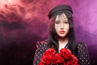 A Woman in Black and White Polka Dot Long Sleeves Wearing Black Beret