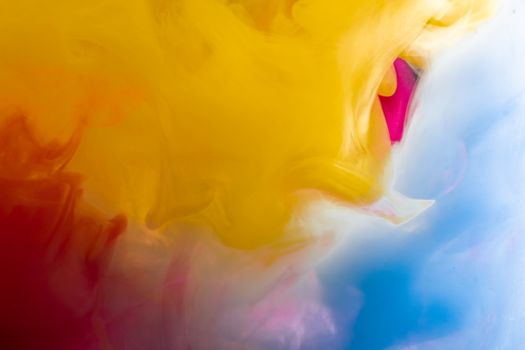 Colorful abstract cloud of smoke with vibrant yellow, red, and blue hues blending seamlessly.
