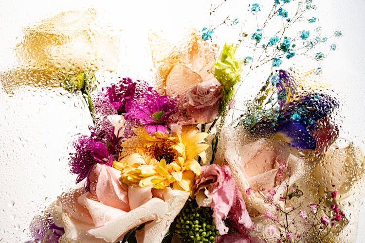 Colorful Bouquet Behind A Wet Glass 