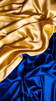 Luxurious drapery in rich gold and blue silk showcasing elegant textile textures.