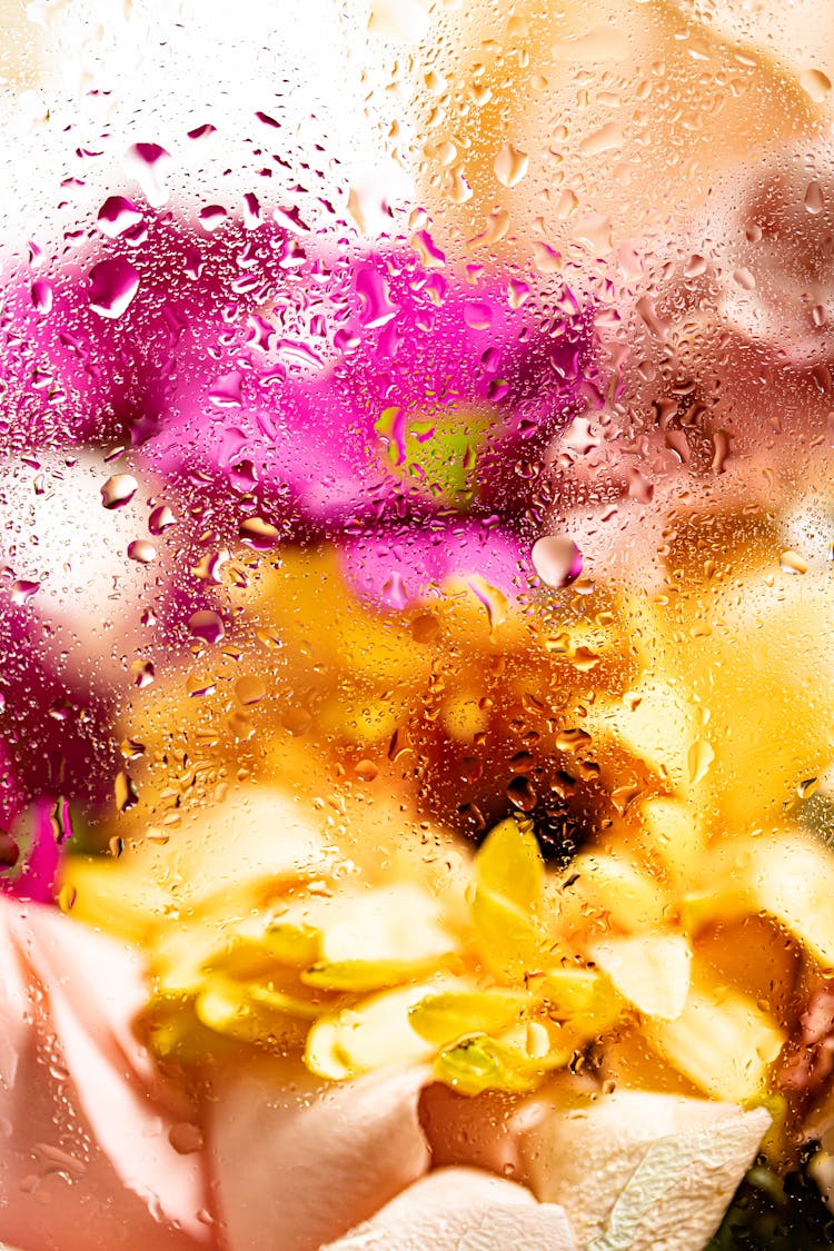 Colorful Bouquet Behind A Wet Glass 