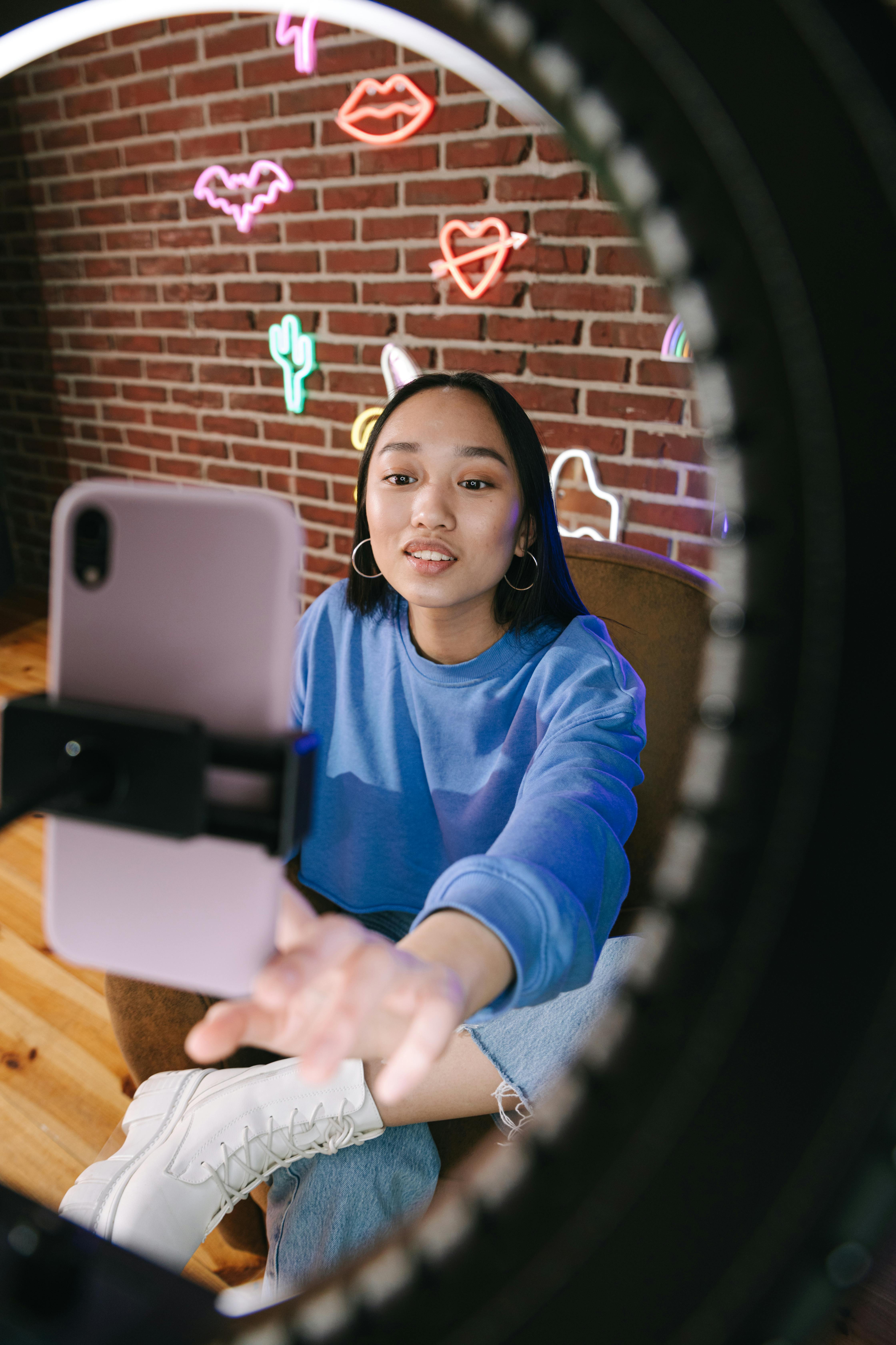 a woman recording herself with a smartphone