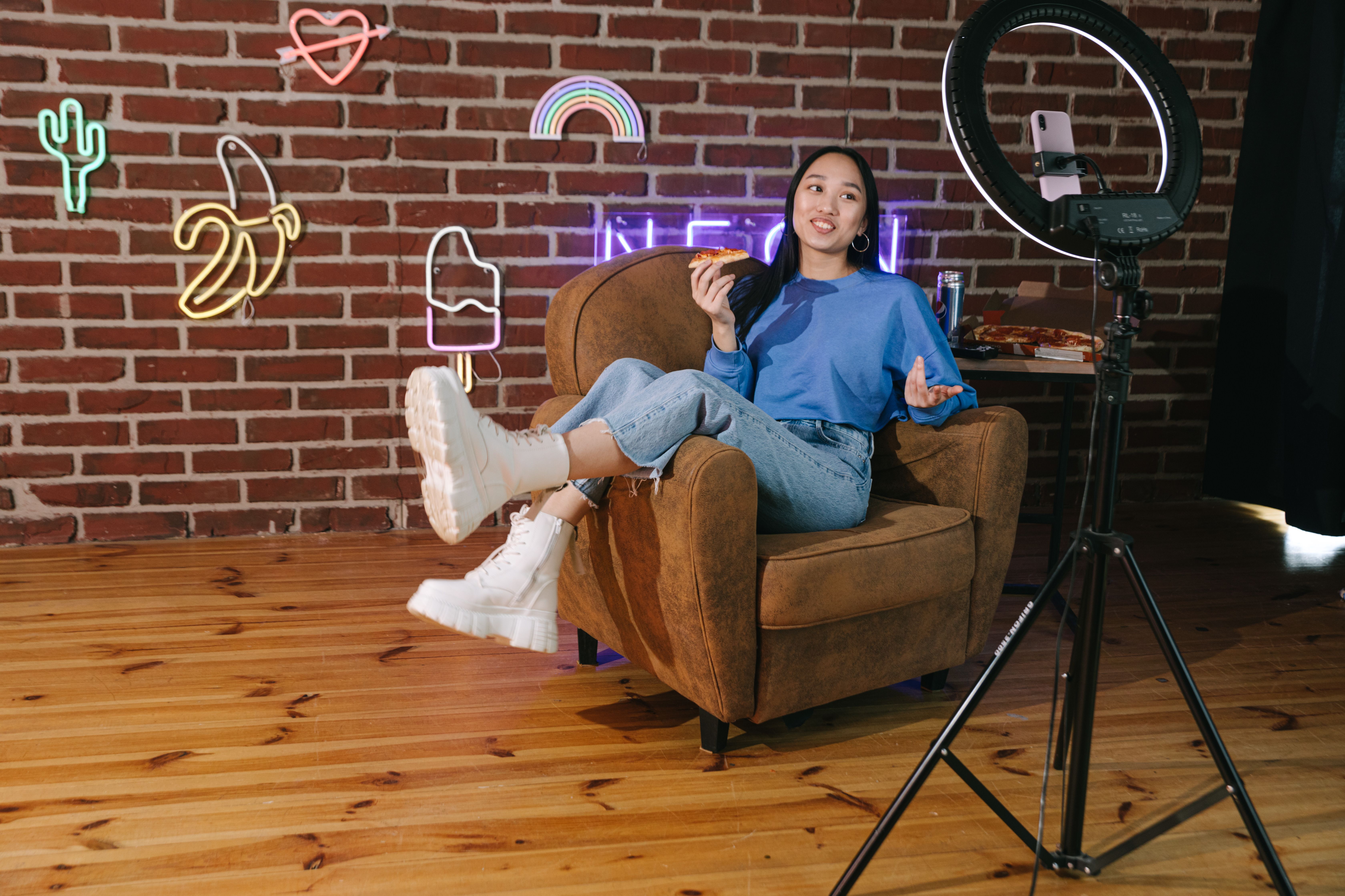 A woman creating content while sitting on the couch.