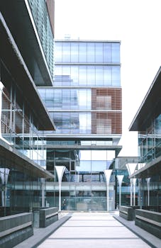 Contemporary glass office buildings in an urban setting with reflective windows.